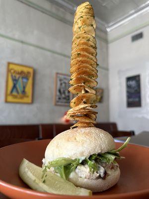 Chicken salad on a sour dough bun with potato tornado in the Enoteca.