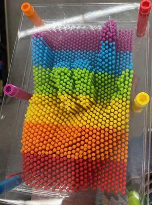 Such a pretty rainbow ILY hand! One of those pin art sensory toys. I was just having some fun in the store, while shopping! :)