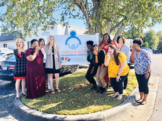 MPPFC staff pose for NC Crunch Day 2019 in celebration of eating healthy, locally-grown produce!