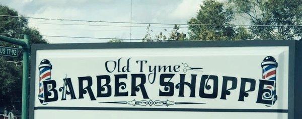 Street sign for the Old Tyme Barber Shoppe