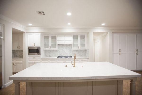 Kitchen refinish with large quartz counter top island and elegant Brizo plumbing fixtures