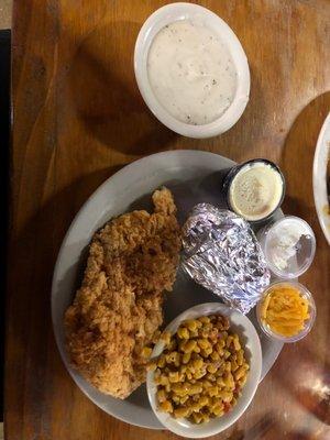 Chicken fried chicken , baked potato, corn , gravy on side