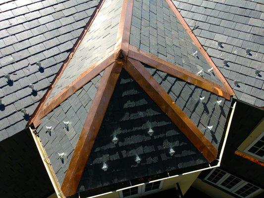 This natural slate roof in Arlington, VA has the copper picture frame treatment! Copper hips and valleys.