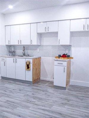 New cabinets with wood flooring