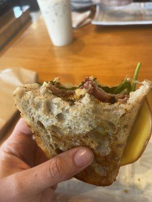 Ham + Cheese with honey mustard, pickles and greens on perfectly toasted sourdough bread