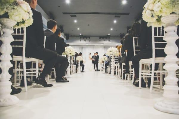 Bride and Groom getting married in our white ballroom