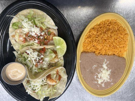 shrimp tacos 3 flour tortillas topped withlettuce,cheeseand chipotle sauce