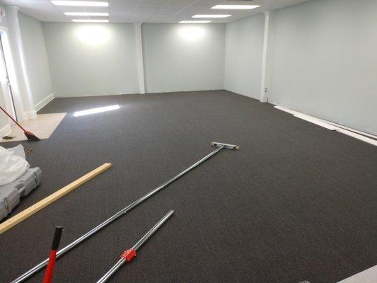 Commercial carpet being installed in an office.