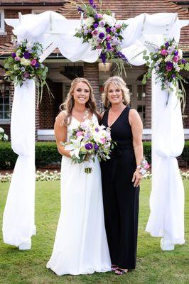 Florals on the arch, bouquet, and mother of the bride corsage all from Affordable Flowers.