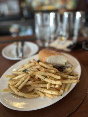 Half of the steak sandwich with fries, delicious!