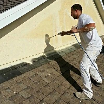 spraying stucco with a freash coat of paint