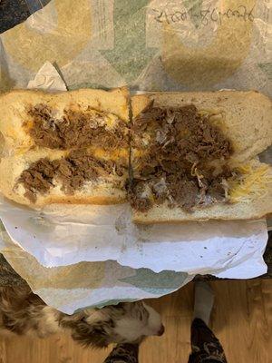 Apparently a steak and cheese sandwich, with almost no meat.