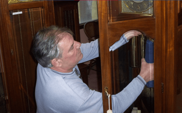 Working on an old grandfather clock.