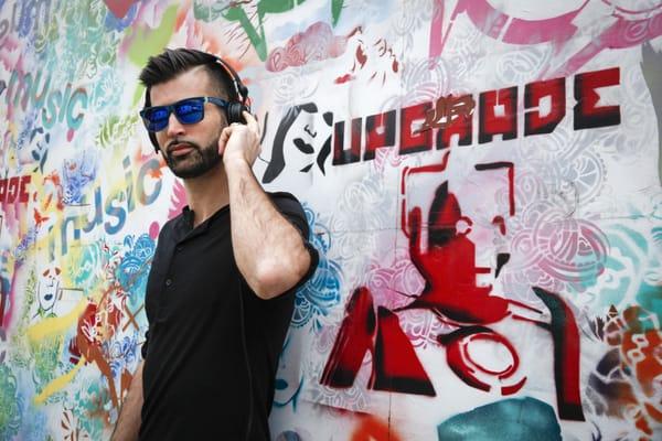 DJ Yanic photographed by Nicole Craine in front of local street art.