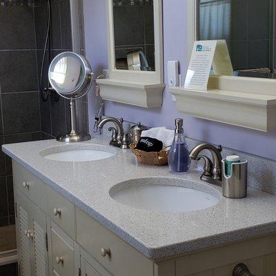 The Sycamore Room bathroom has two sinks and magnification make-up mirror