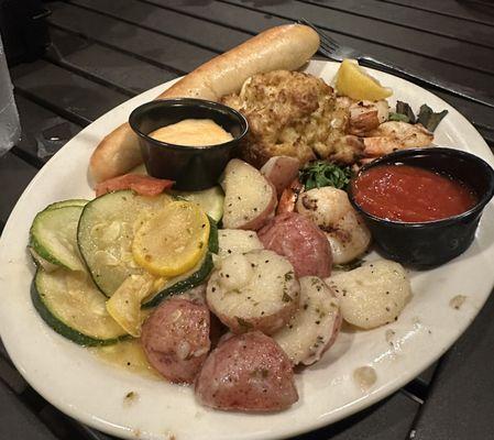 Crabcake, grilled shrimp, parsley potatoes, squash and zucchini medley and fresh bread stick.