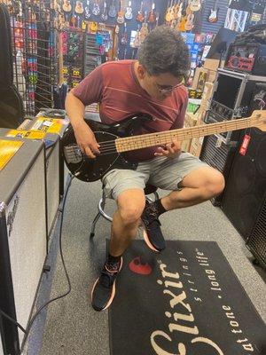 Nathan playing a bass guitar