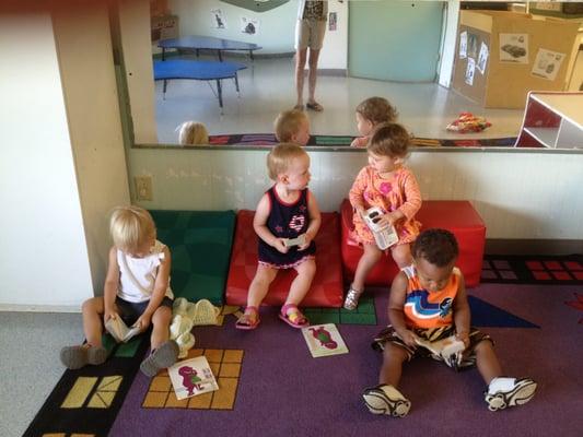 The toddler "book club" meets everyday.  Sharing books helps toddlers develop language and communication skills.