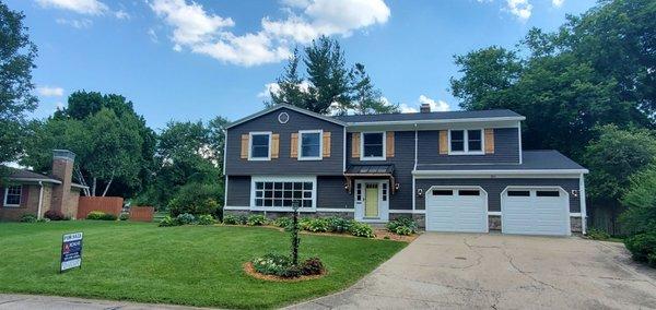 Beautif new siding and portico and stone work by Scott Bauer Roofing