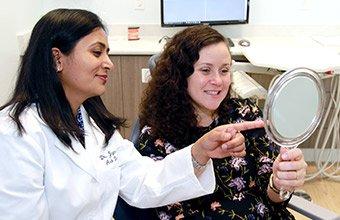 Dr. Khetani is a very skilled cosmetic dentist.  Here she is with a patient going over the results.