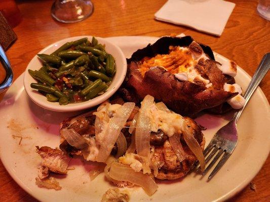 Smothered chicken with Jack cheese, loaded sweet potato and green beans.