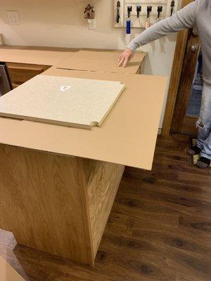 Guy measuring the counter tops with card board. Crazy