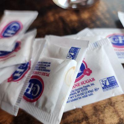 Stains on the sugar packets. Which means it had already been to someone else's table.