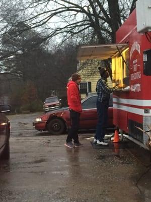 Customers placing orders from this food truck/food stand