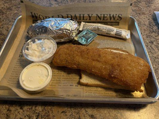 Fried cod dinner with baked potato and coleslaw.