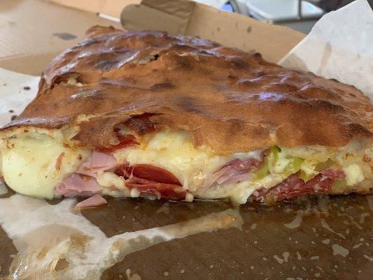 Half of the Large Italian Stromboli with salami and banana peppers.