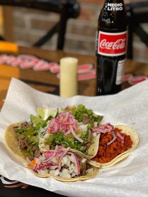 Two lengua, two asada and one chorizo tacos.