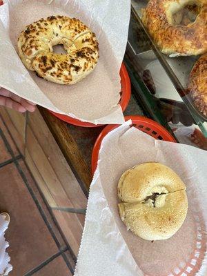 top: garlic bagel with sun dried Flavored Cream Cheese. bottom: sourdough bagel with garlic and herb Flavored Cream Cheese