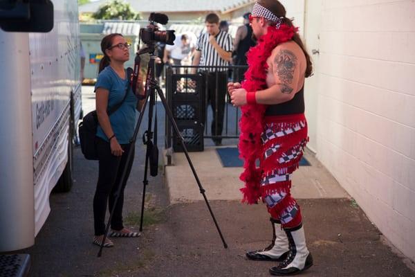 Digital producer Marnette Federis taking some video of a wrestler.