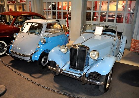 An MG-TD and a BMW Isetta, also known as a bubble car, or unfortunately a Steve Erkle car.