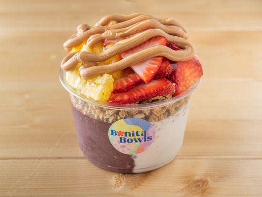 MANDO - HALF AÇAI HALF COCONUT, TOPPED WITH STRAWBERRY, PINEAPPLE, PEANUT BUTTER, & HONEY.