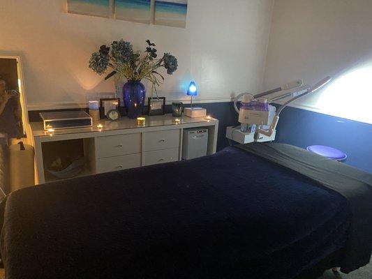 blue esthetics room. experience facials, waxing, & other advanced treatments with Aromatherapy candles for release & relaxation.