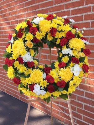 $185 standing wreath with roses, mums, carnations and lemon greens