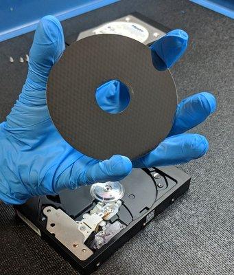 This is a hard drive platter.  They're pretty - especially when they haven't been accidentally damaged.