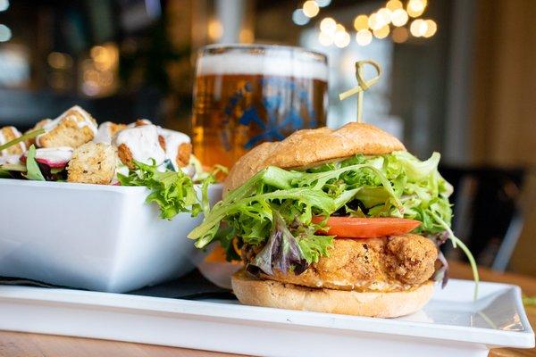 CRAB CAKE SANDWICH: Blue crab cake, lettuce, tomato, remoulade sauce, brioche bun.