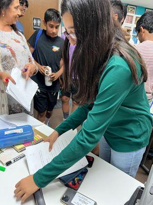 Students turning in their homework.