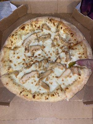 pointed to the jalapeño that was on the top of the chicken Alfredo pizza. How does that even end up on this pizza.