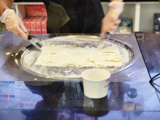 Snickers cream being spread to start setting into ice cream