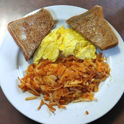 Scrambled eggs, wheat toast, and hash browns