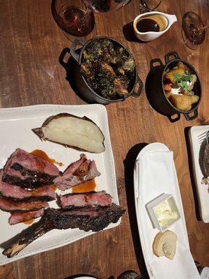 Prime rib served table side with roasted carrots and crispy Brussels