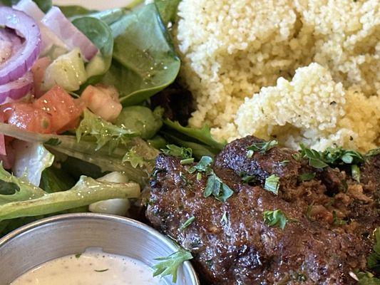 Kofta Platter with couscous and salad.