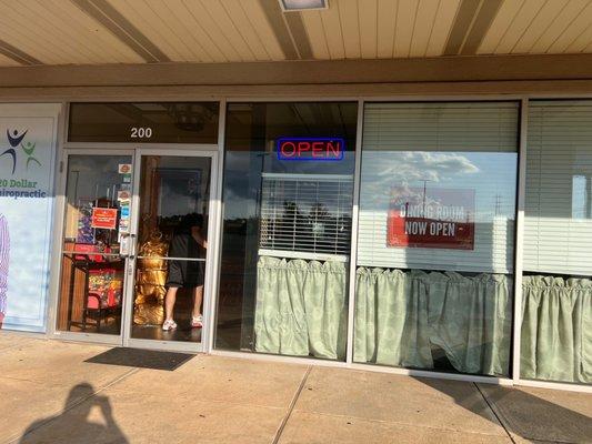 Front door of business inside strip mall.