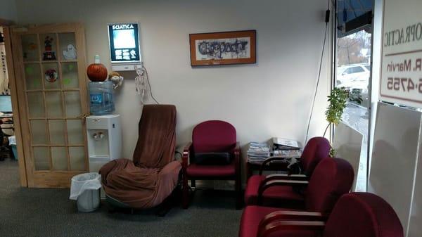 Our waiting room with a complimentary massage chair.