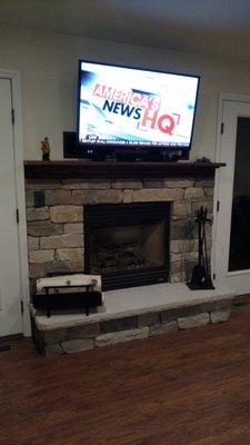 Michigan Asher stone with 2 inch radius corner Limestone hearth Oak mantel two built-in boxes with wire chases for electronics.