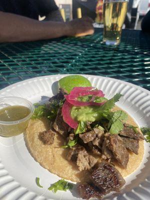 Taco de Asada- freshmade corn tortilla , tender steak , guacamole, pickled onion