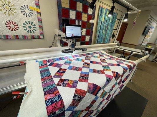 Quilting my quilt on one of their APQS machines that are available to rent.